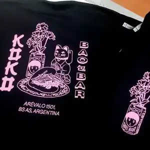 Serigrafía en color neón sobre remera negra - Diseño oriental Remera negra serigrafía rosa neón con diseño asiático y caracteres